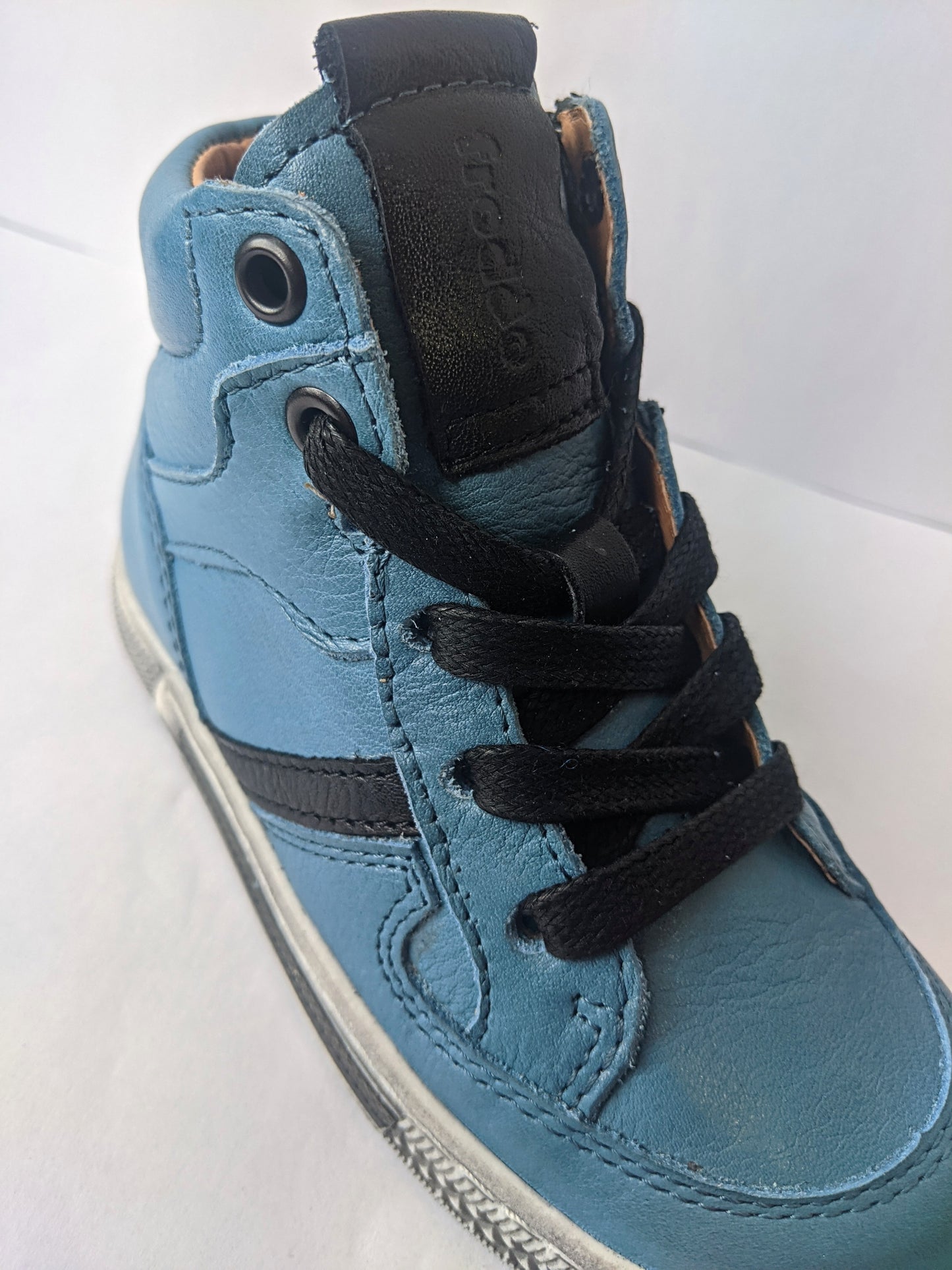 A boys casual hi top boot by Froddo,style G3110128-1, in Teal leather with lace and zip fastening. Angled view.