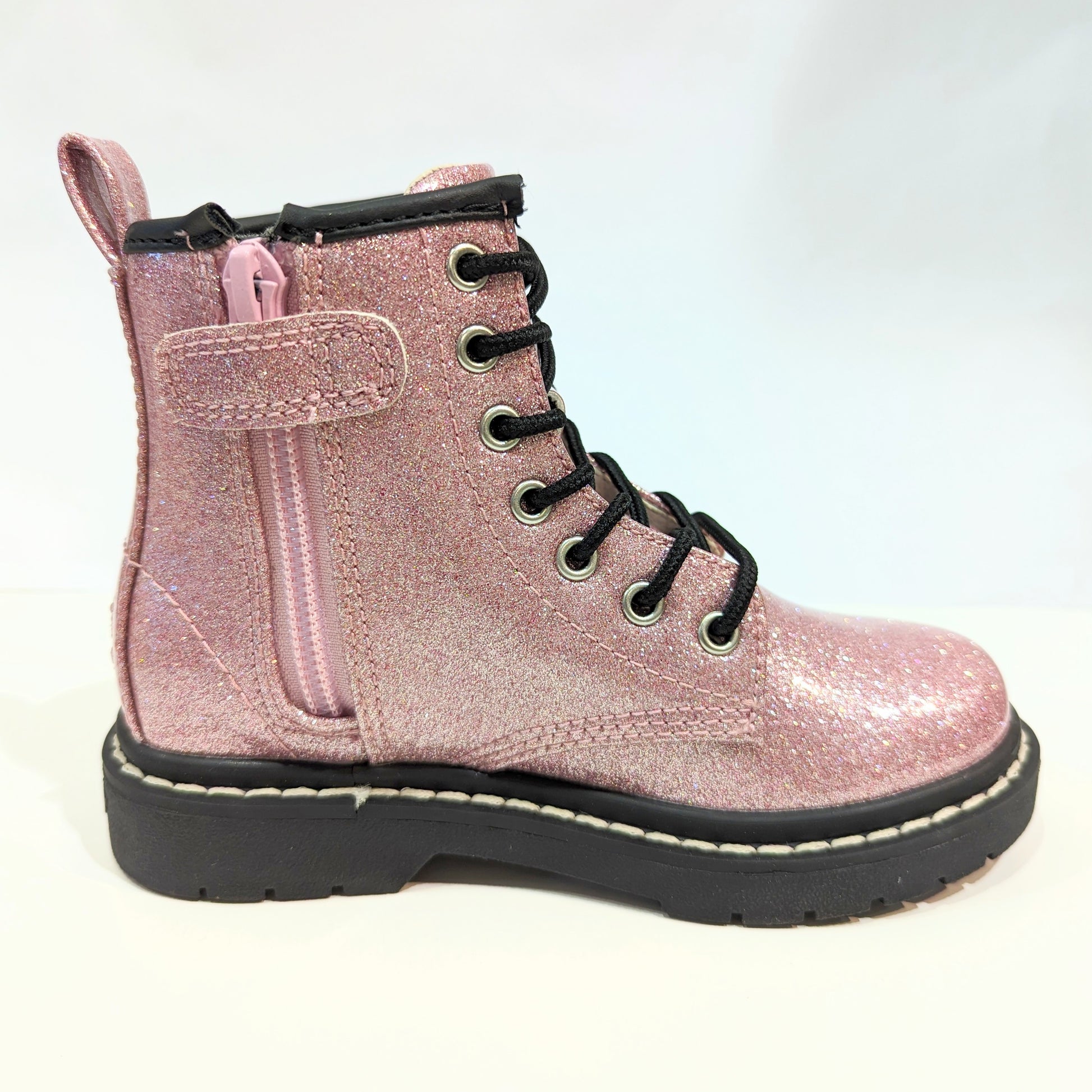 A girls boot by Lelli Kelly, style Emma, in pink glitter patent with zip and lace fastening. Right side view.