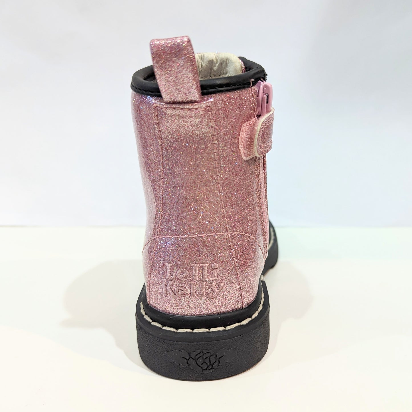 A girls boot by Lelli Kelly, style Emma, in pink glitter patent with zip and lace fastening. Back view of embroidery.