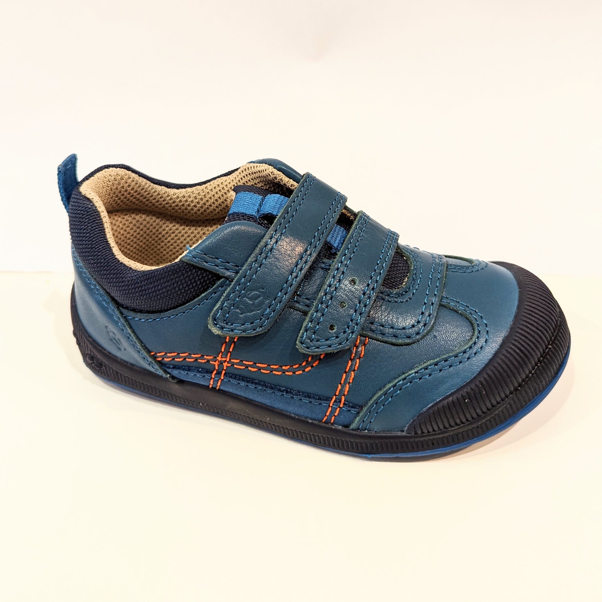 A boys casual shoe by Start Rite, style Tickle, in teal leather with double velcro fastening. Angled view.