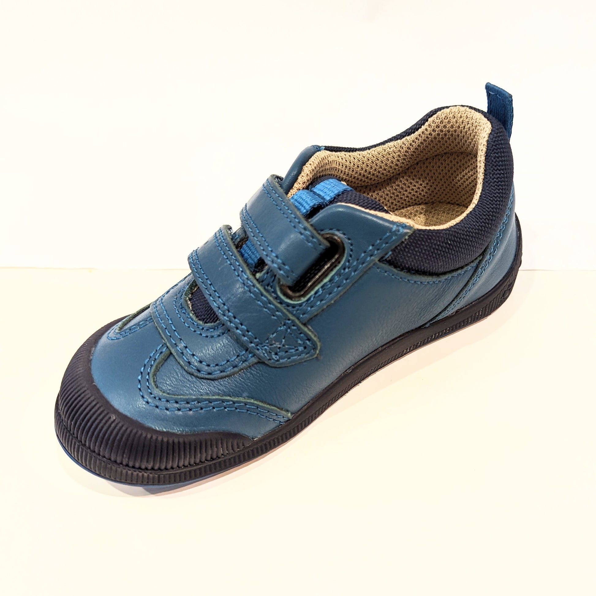 A boys casual shoe by Start Rite, style Tickle, in teal leather with double velcro fastening. Angled view.