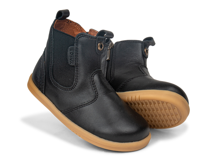 A pair of unisex zip Chelsea boots by Bobux, style KP Jodphur, in black leather with zip fastening. Angled view.