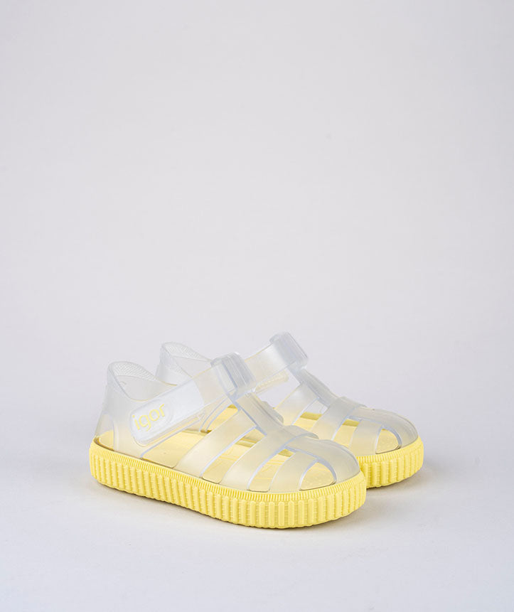 A pair of unisex closed toe sandals by Igor, style Nico, in clear and yellow with velcro fastening. Right side view.