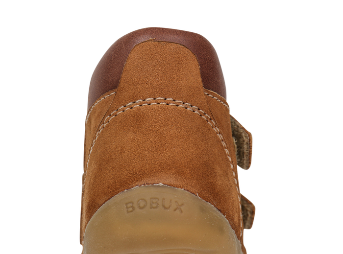 A boys ankle boot by Bobux,style Timber, in Tan nubuck and brown leather with double velcro fastening. Close up heel view.
