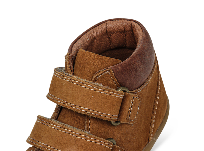 A boys ankle boot by Bobux,style Timber, in Tan nubuck and brown leather with double velcro fastening. Close up ankle view.