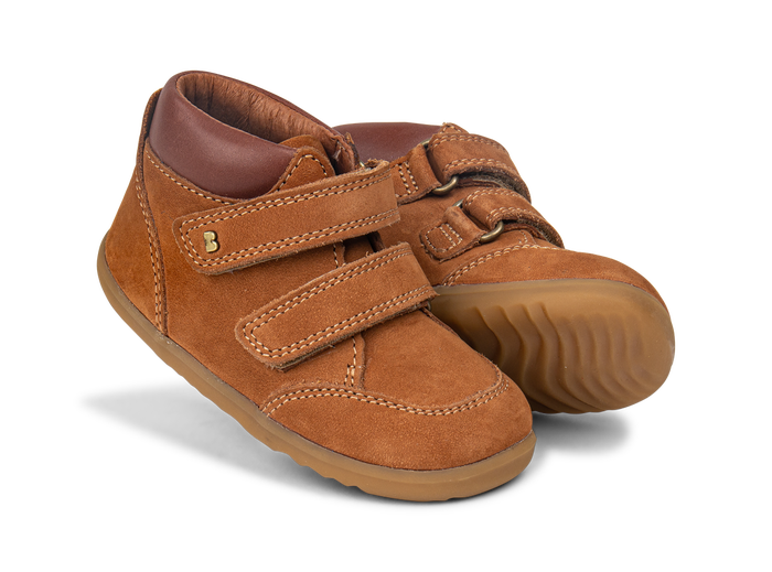 A pair of boys ankle boots by Bobux,style Timber, in Tan nubuck and brown leather with double velcro fastening.Angled view.