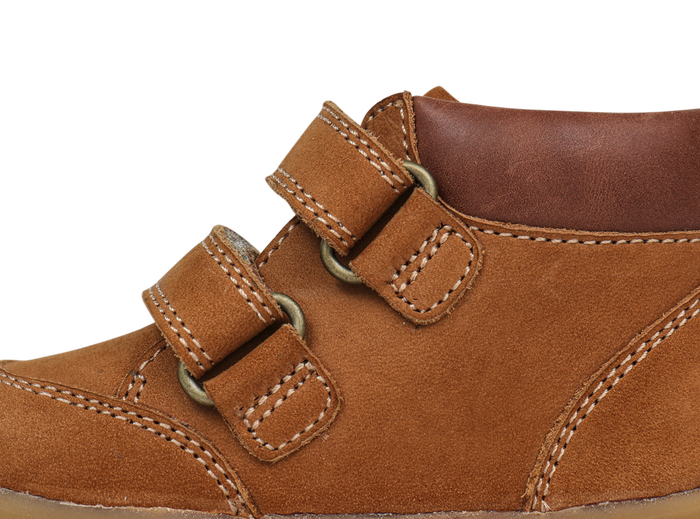 A boys ankle boot by Bobux,style Timber, in Tan nubuck and brown leather with double velcro fastening.  Close up left side view.