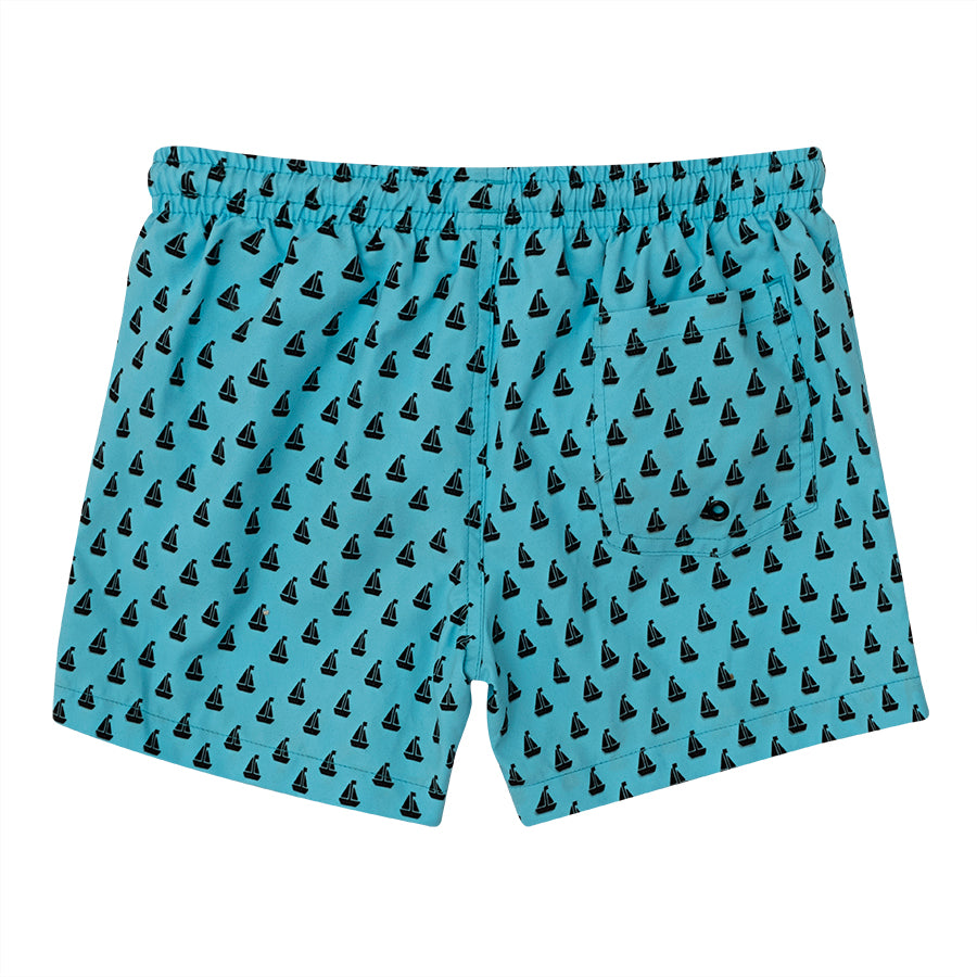 A pair of boys swim shorts by Slipfree, style Peter, in blue with black boat print. Back view.