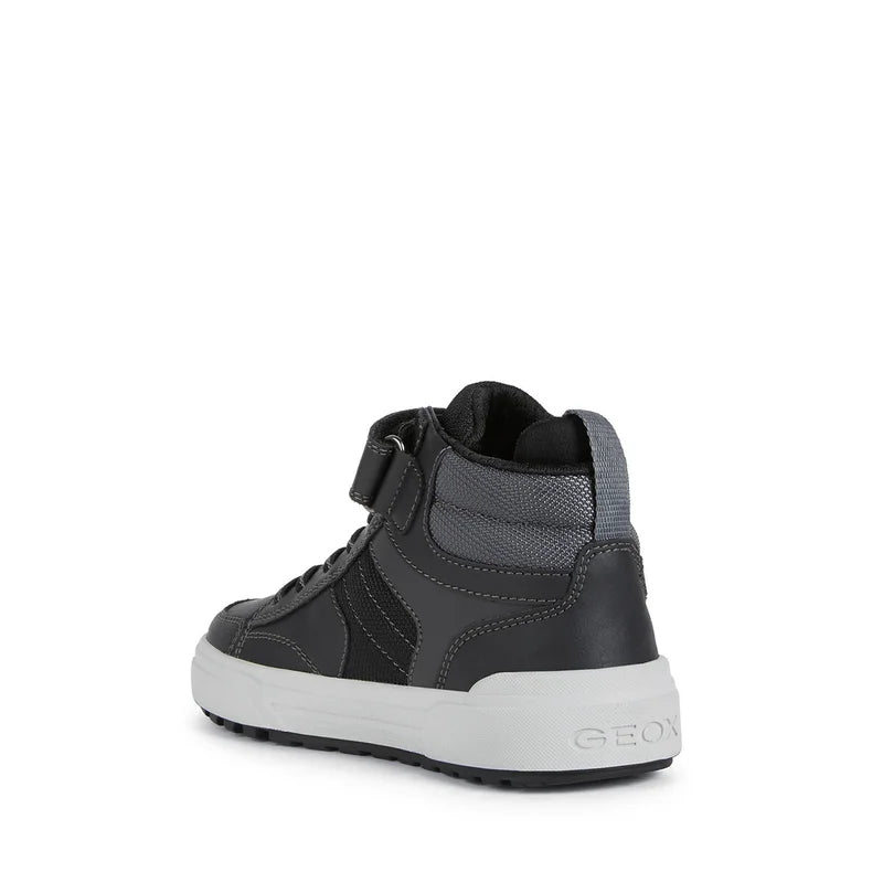 A boys Hi-top by Geox, style J Weemble Boy, in black and grey, velcro fastening with elastic laces. Back angled view.