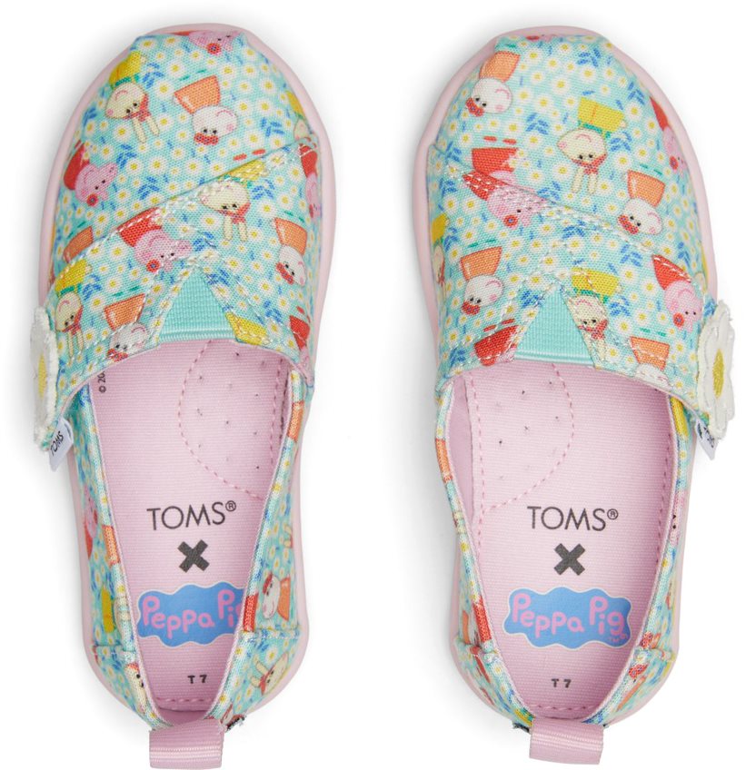 A girls canvas shoe by TOMS, style Alpargata Peppa Pig, in light jade Peppa Pig print, and a velcro strap with daisy detail. Top view of a pair.