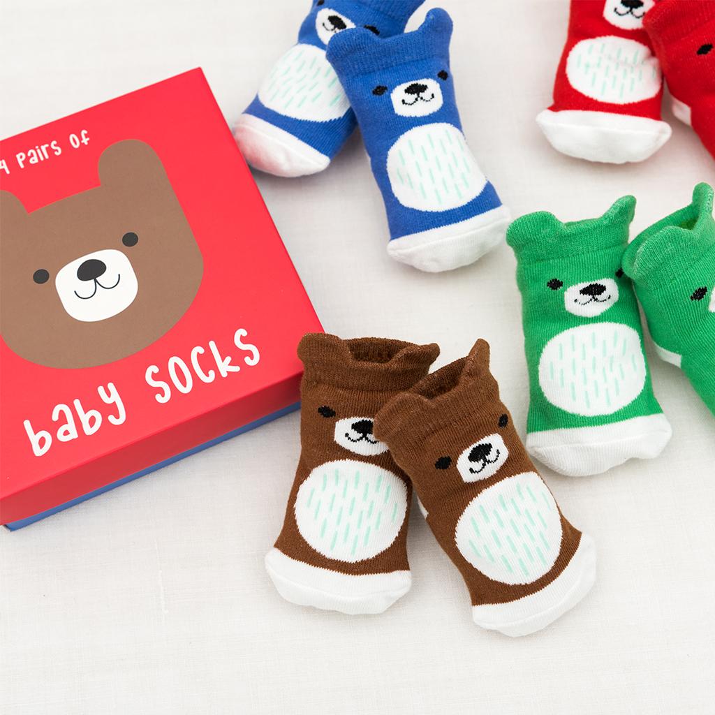 4 pairs of baby socks in a red bear design box by Rex London, style Bear, in blue, green ,brown, and red bear design. View of socks in pairs.