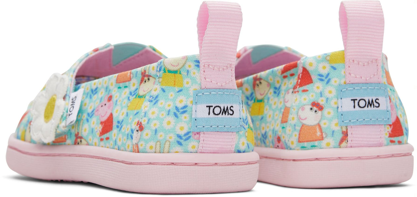 A girls canvas shoe by TOMS, style Alpargata Peppa PIg, in light jade Peppa Pig print, and a velcro strap with daisy detail. Back view of a pair.