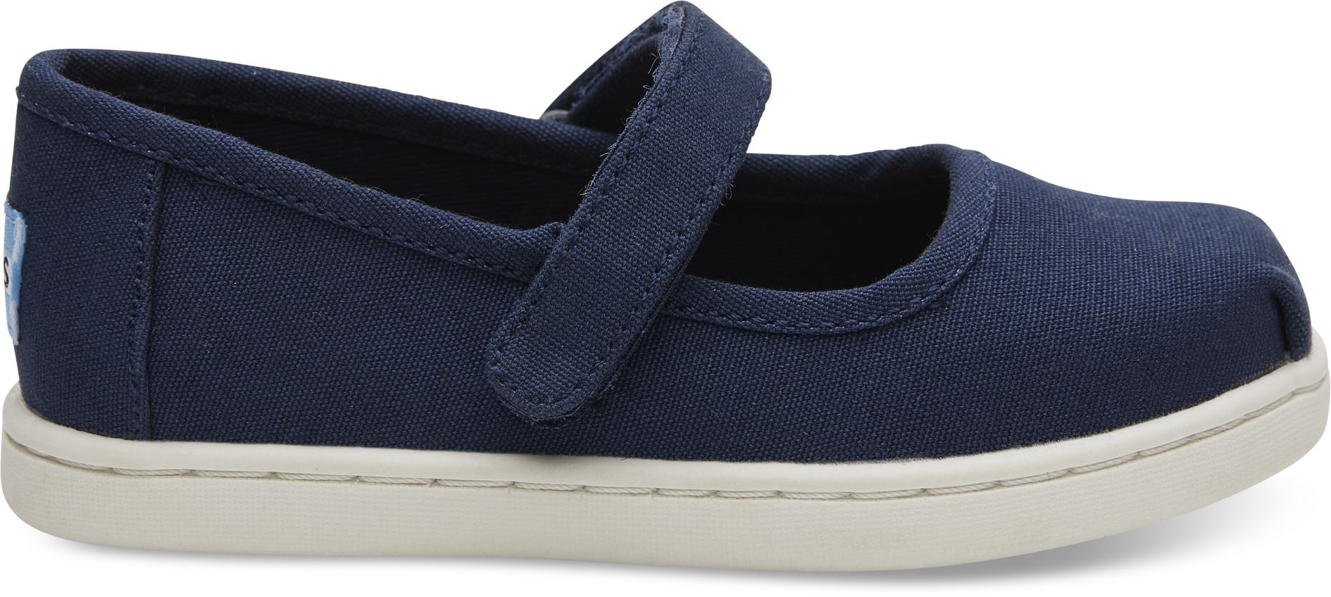 A girls canvas shoe by TOMS, style Mary Jane, in navy denim with a velcro strap. Right side view.