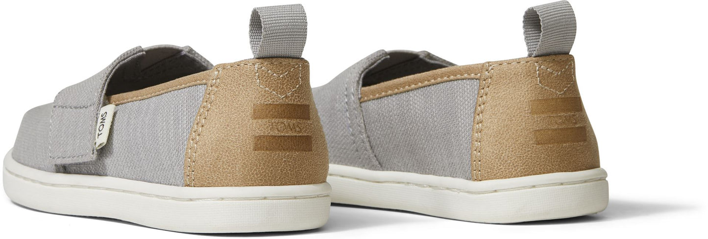 A unisex canvas shoe by TOMS, style Alpargata, in Drizzle Grey and Tan. Back view of a pair.
