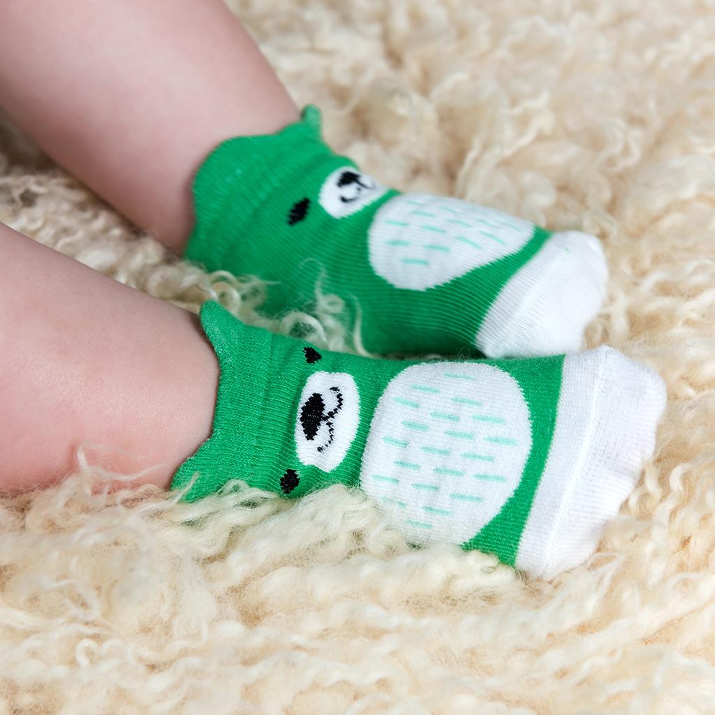 A pair of baby socks in green bear design by Rex London, style Bear. Lifestyle
