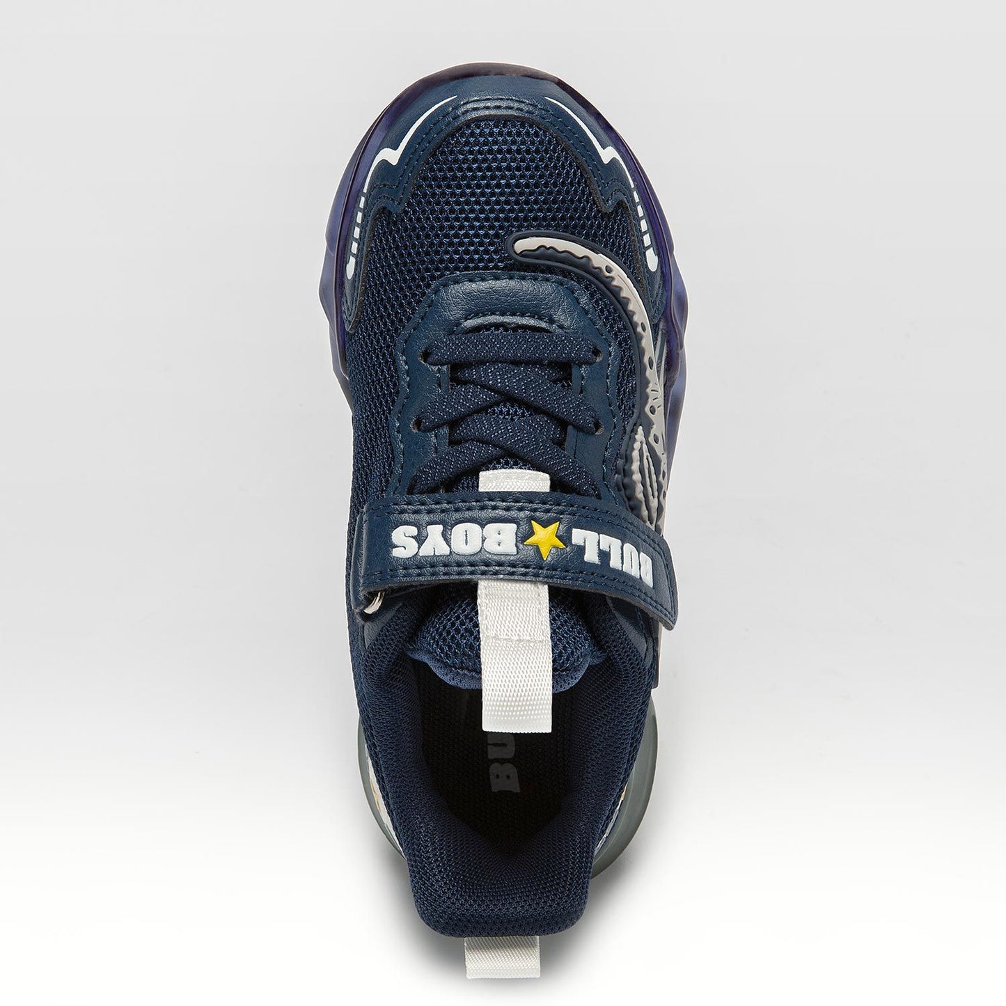 A boys trainer by Bull Boys, style Spinosauro, in navy blue with grey dinosaur in 3D and flashing sole. Velcro and elastic faux lace fastening. Top view.
