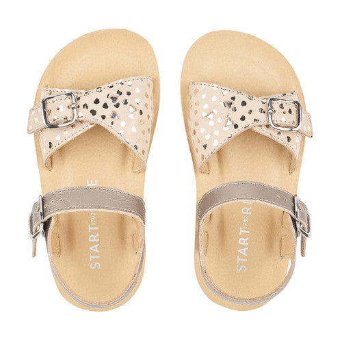 A pair of girls sandals by Start Rite ,style Enchant, in gold leather with buckle fastening. Top view.