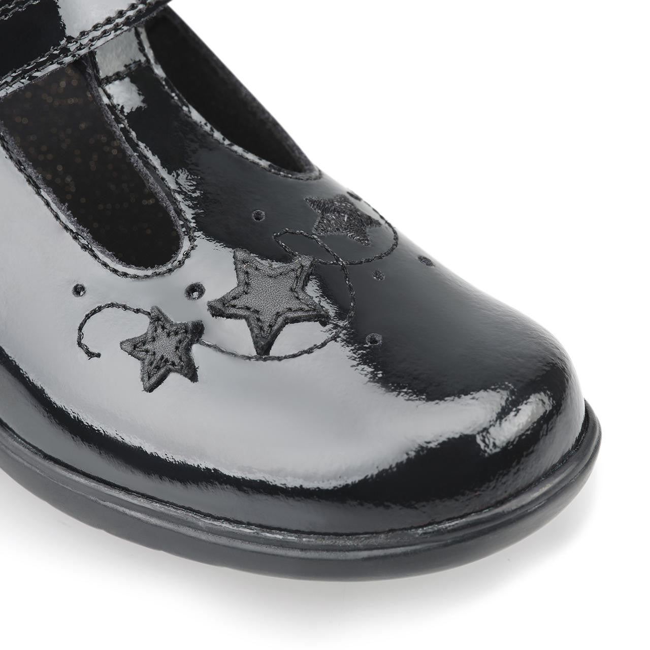 A girls school shoe by Start Rite, style Star Jump, in black patent with velcro fastening. Close up view.