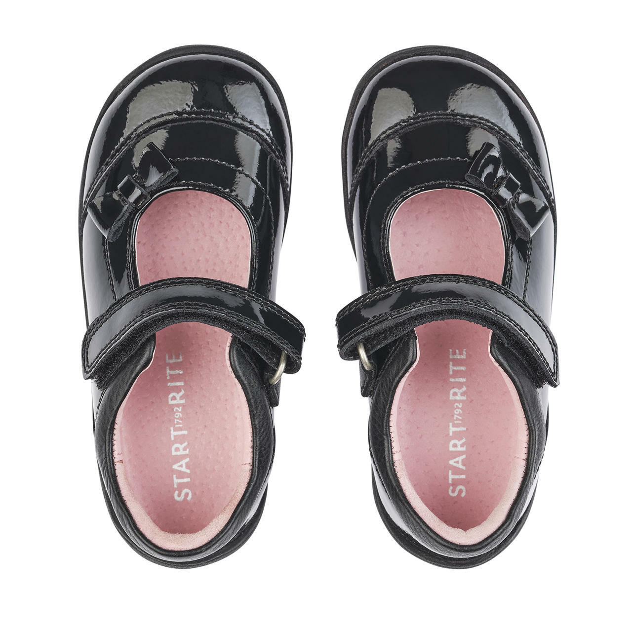 A pair of girls pre school shoes by Start Rite, style Twizzle, in black patent with velcro fastening. Above view.