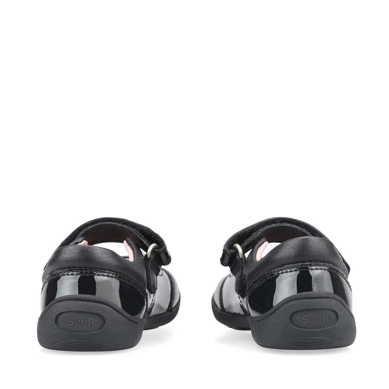 A pair of girls pre school shoes by Start Rite, style Twizzle, in black patent with velcro fastening. Back view.